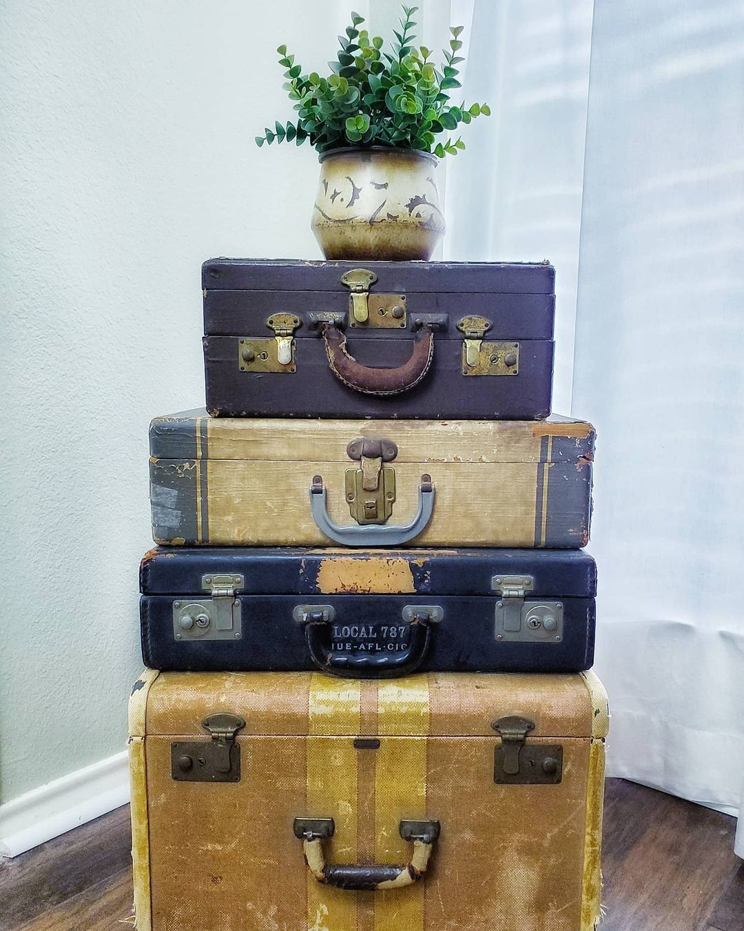 Four stacked trunks used as repurposed decor. Photo by Instagram User @lifeonclearance