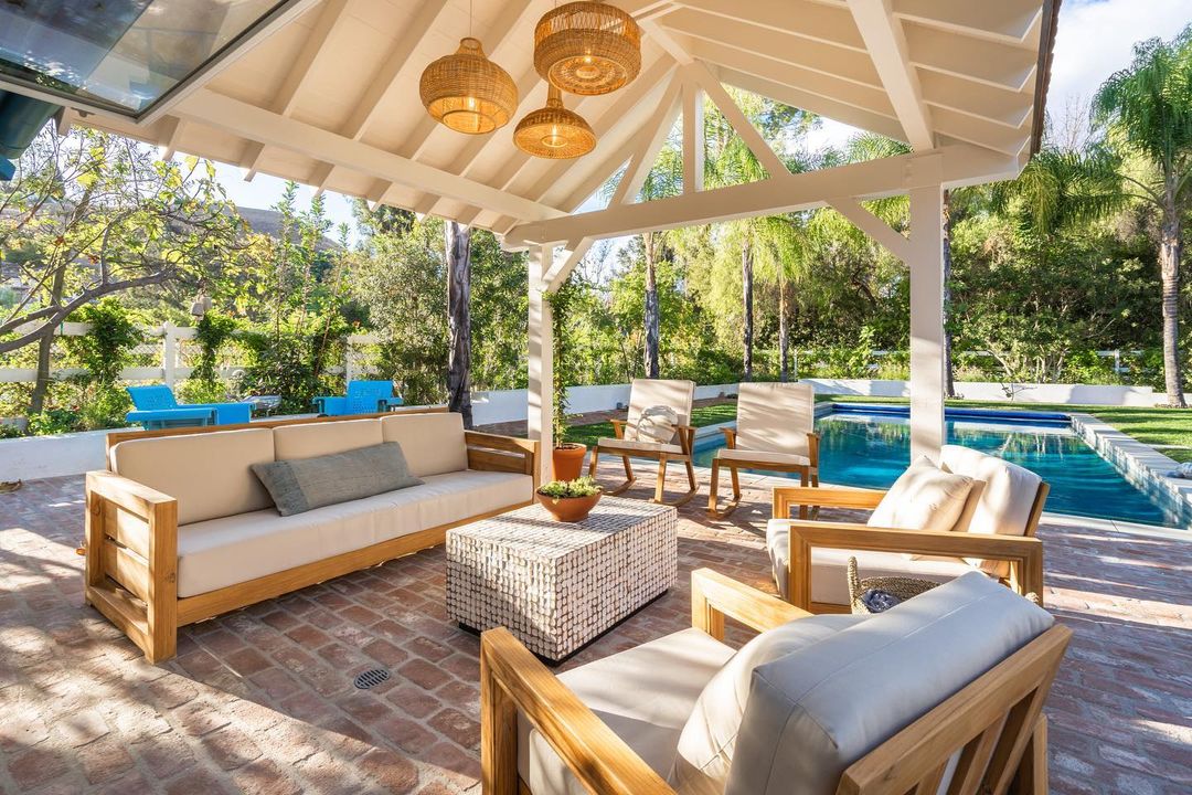 Backyard patio with a pool. Photo by @doneraildesign