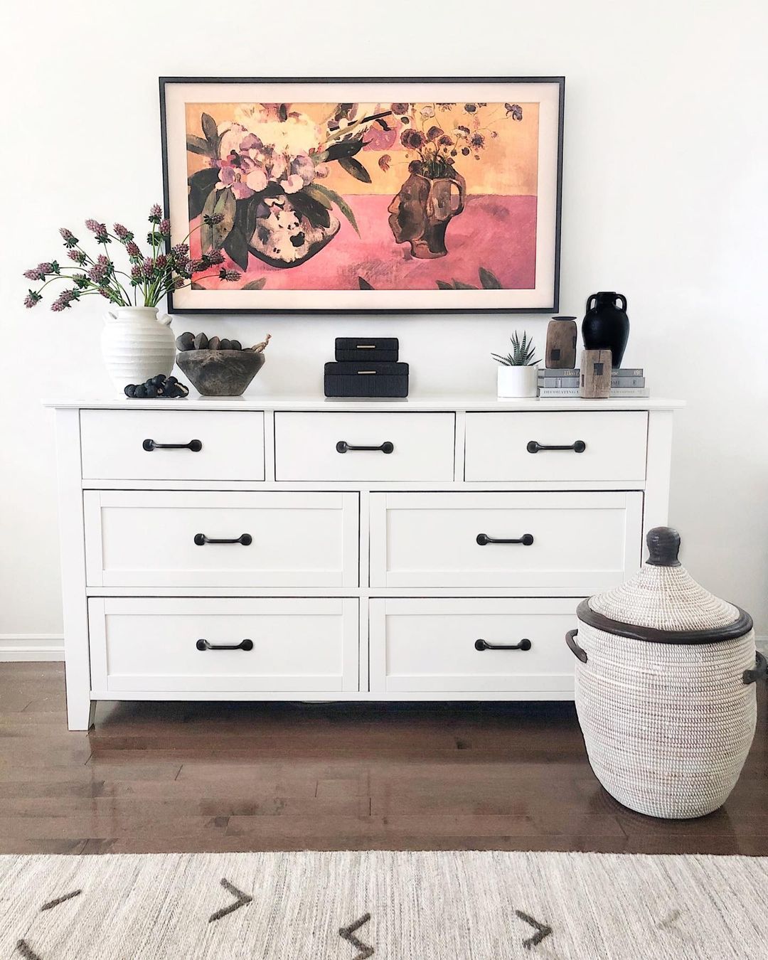 Modern white bedroom dresser with black metal hardware. Photo by Instagram user @theheartandhaven