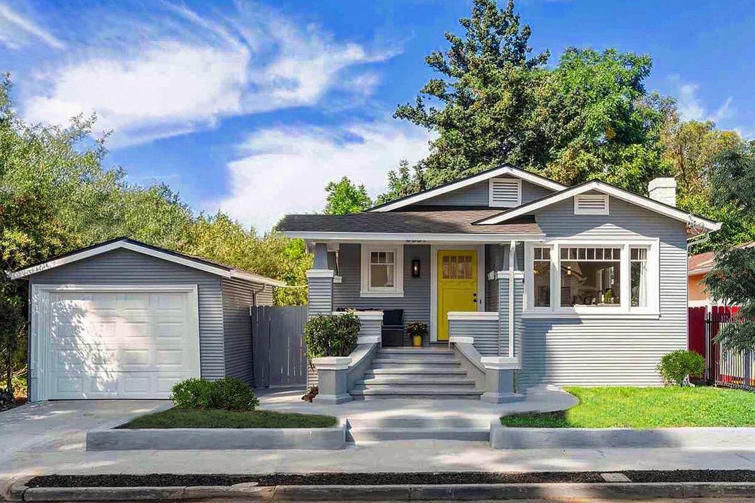 Remodeled Craftsman home with yellow door in Oakland. Photo by Instagram User @bungalowsandcottages