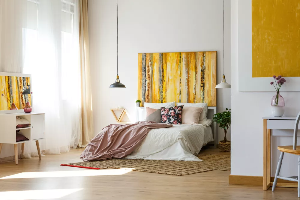 Bright, airy bedroom styled with gold and mauve accents.