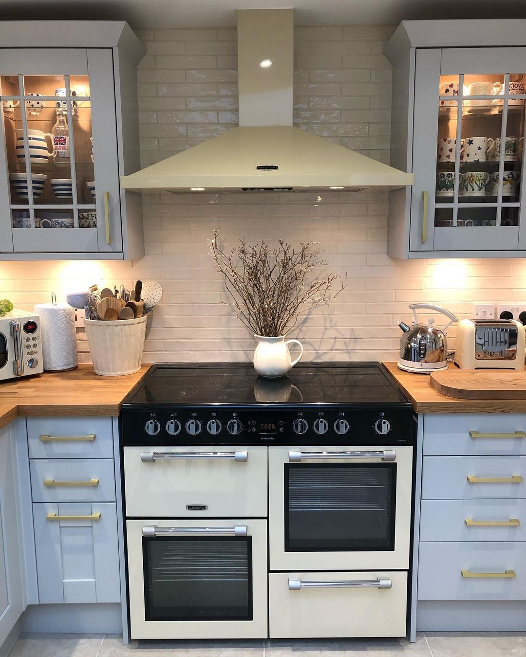 Vintage style white and black oven in a kitchen with light blue cabinetry. Photo by Instagram user @lavender_cottage_living