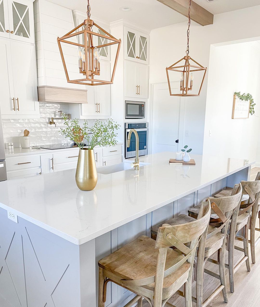 Bright kitchen with white stone countertops and cabinetry. Photo by Instagram user @thewhitehouseonpineridge