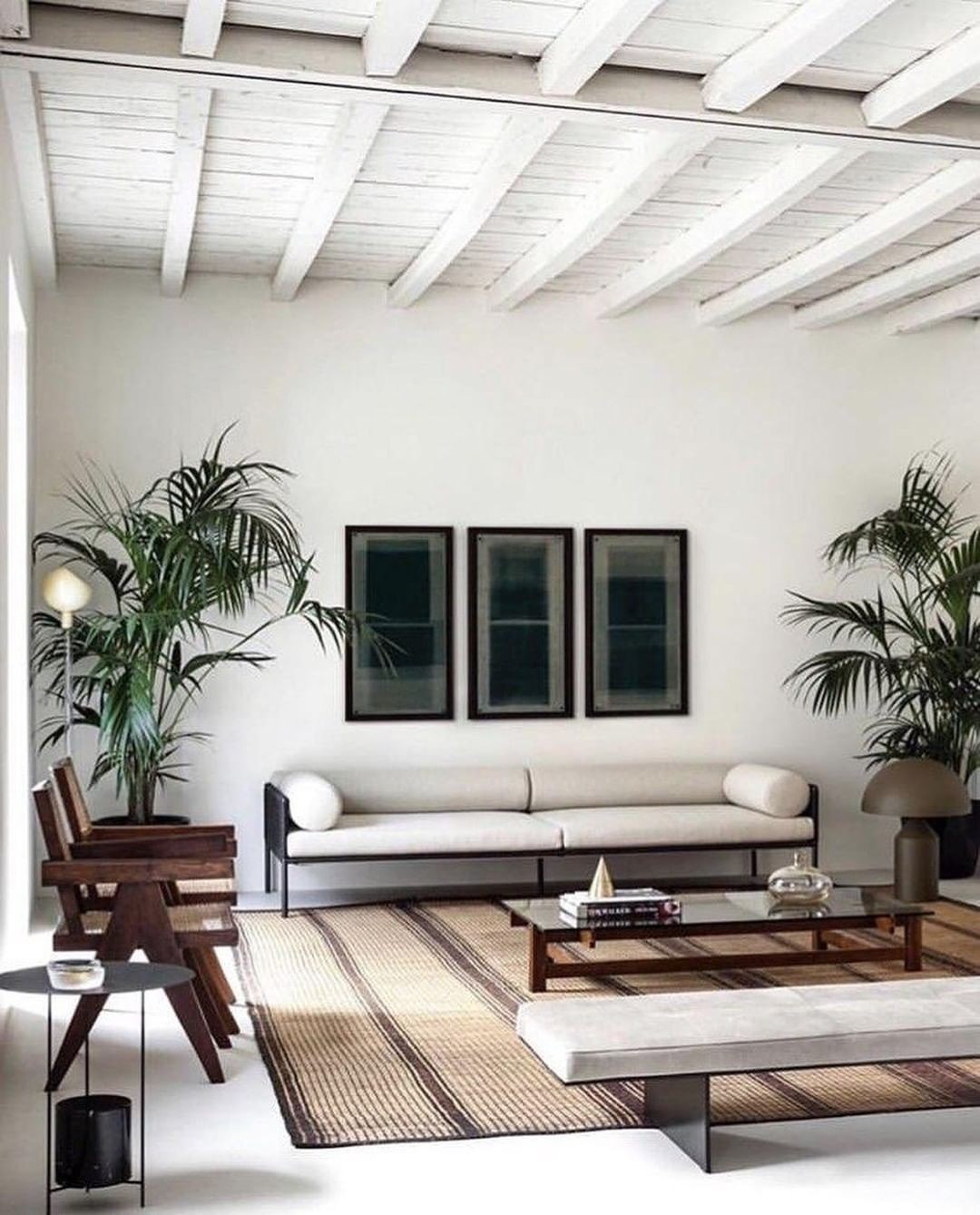 Japandi designed living room with white walls and dark wood furniture. Photo by Instagram user @srelle_studio