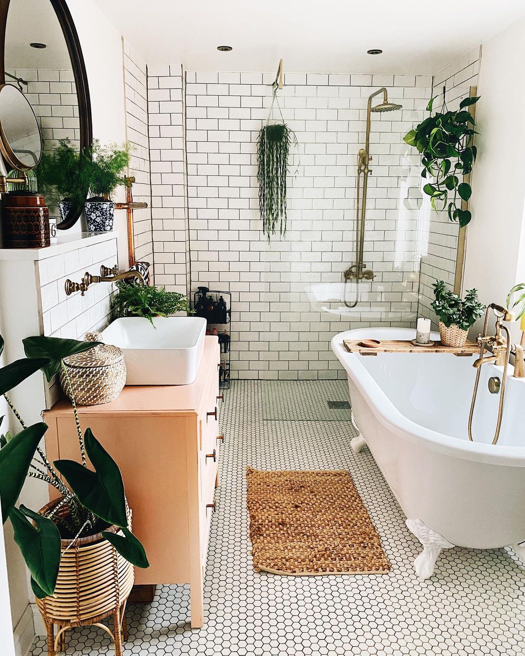 Spotless bathroom with plants, tub, repurposed kitchen sink. Photo by Instagram user @homebythestation.