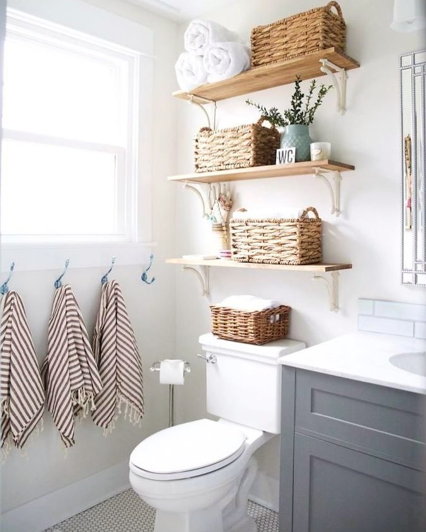 Toilet area with storage shelves in a clean bathroom. Photo by Instagram user @dust.bunniescleaning.