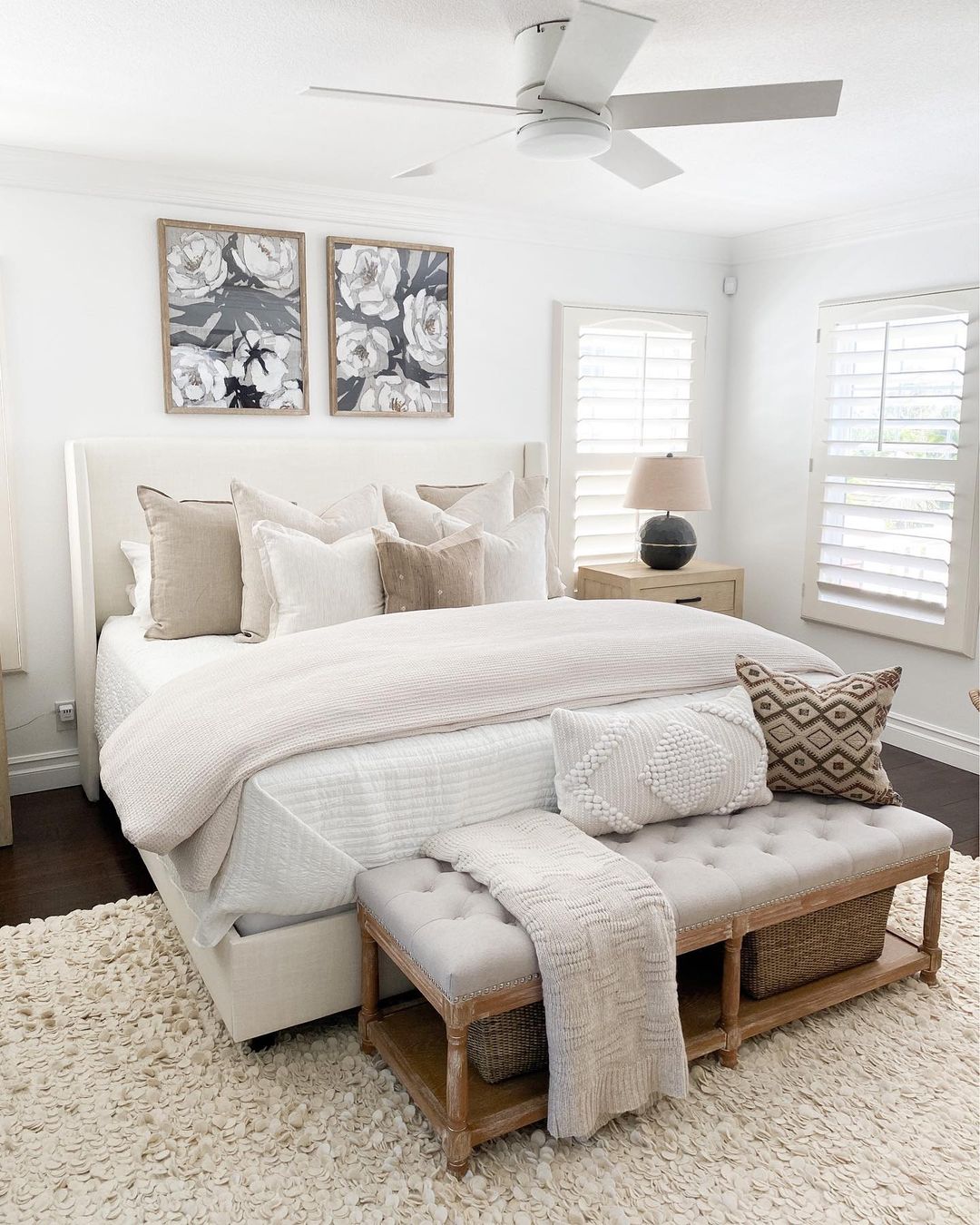 Neutral master bedroom with textured bedding and floral wall art. Photo by Instagram User @house.becomes.home