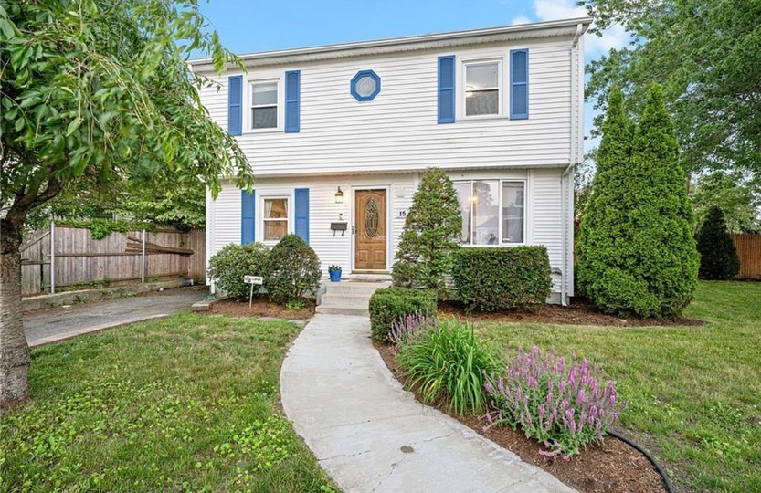 Two-story white home with blue shutters located in the Manton neighborhood in Providence, RI. Photo by Instagram user @thebourdierdgroup.