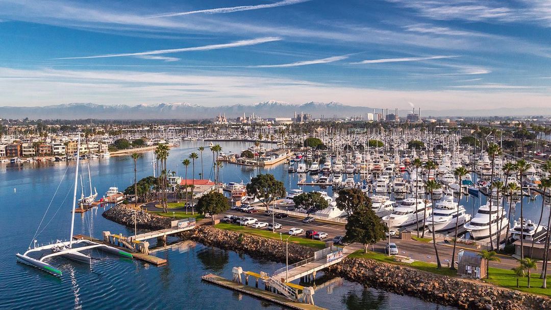Blue skies, light clouds, mountains in the distance, and a whole lot of boats in one of Long Beach's marinas. Photo by Instagram user @ocyachts.