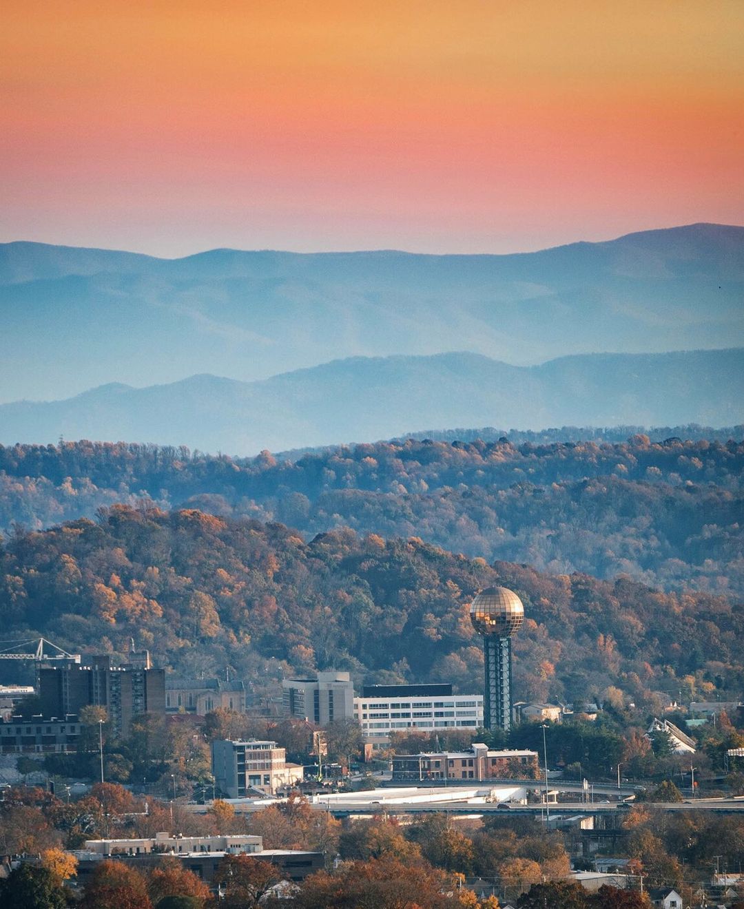 Distant Photo of Downtown Knoxville, TN with the Smoky Mountains in the Background. Photo by Instagram user @mt_productionsandphotos