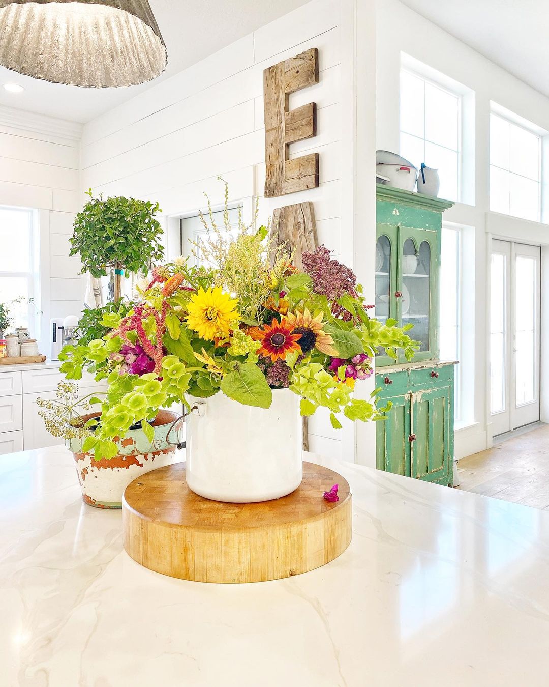 White Farmhouse Kitchen with Fresh Flowers on the Island. Photo by Instagram user @sweetpickins
