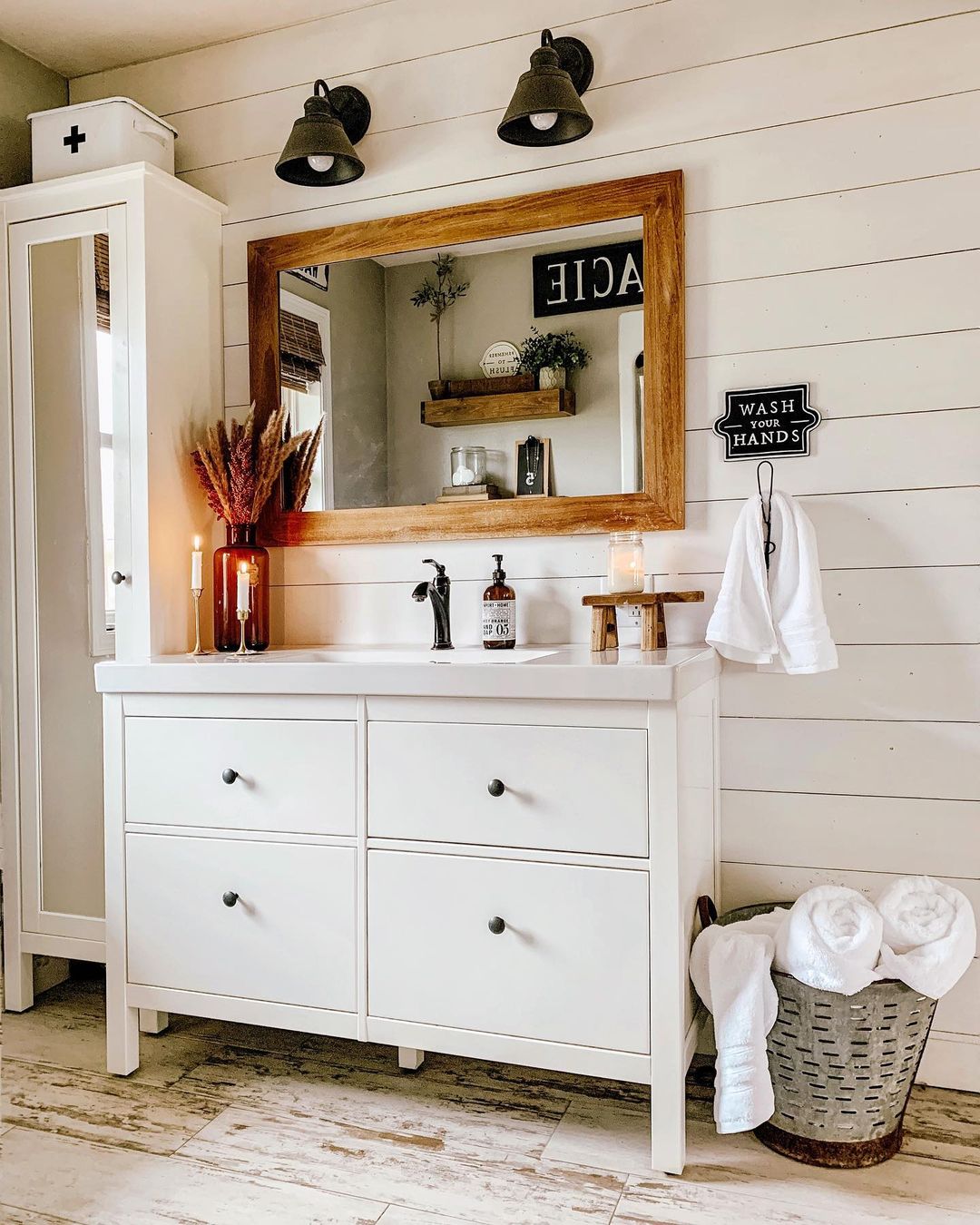 Shiplapped Bathroom with Wood Framed Mirror Above Sink. Photo by Instagram user @our_forever_farmhouse