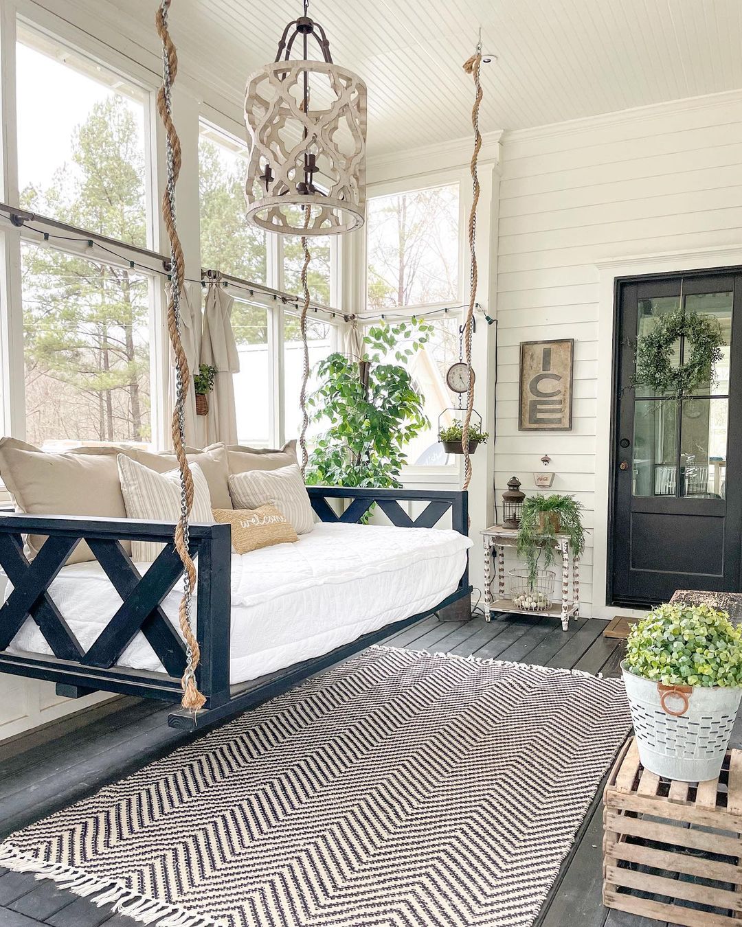 Farmhouse Sunroom with a Hanging Swing. Photo by Instagram user @bigfamilylittlefarmhouse