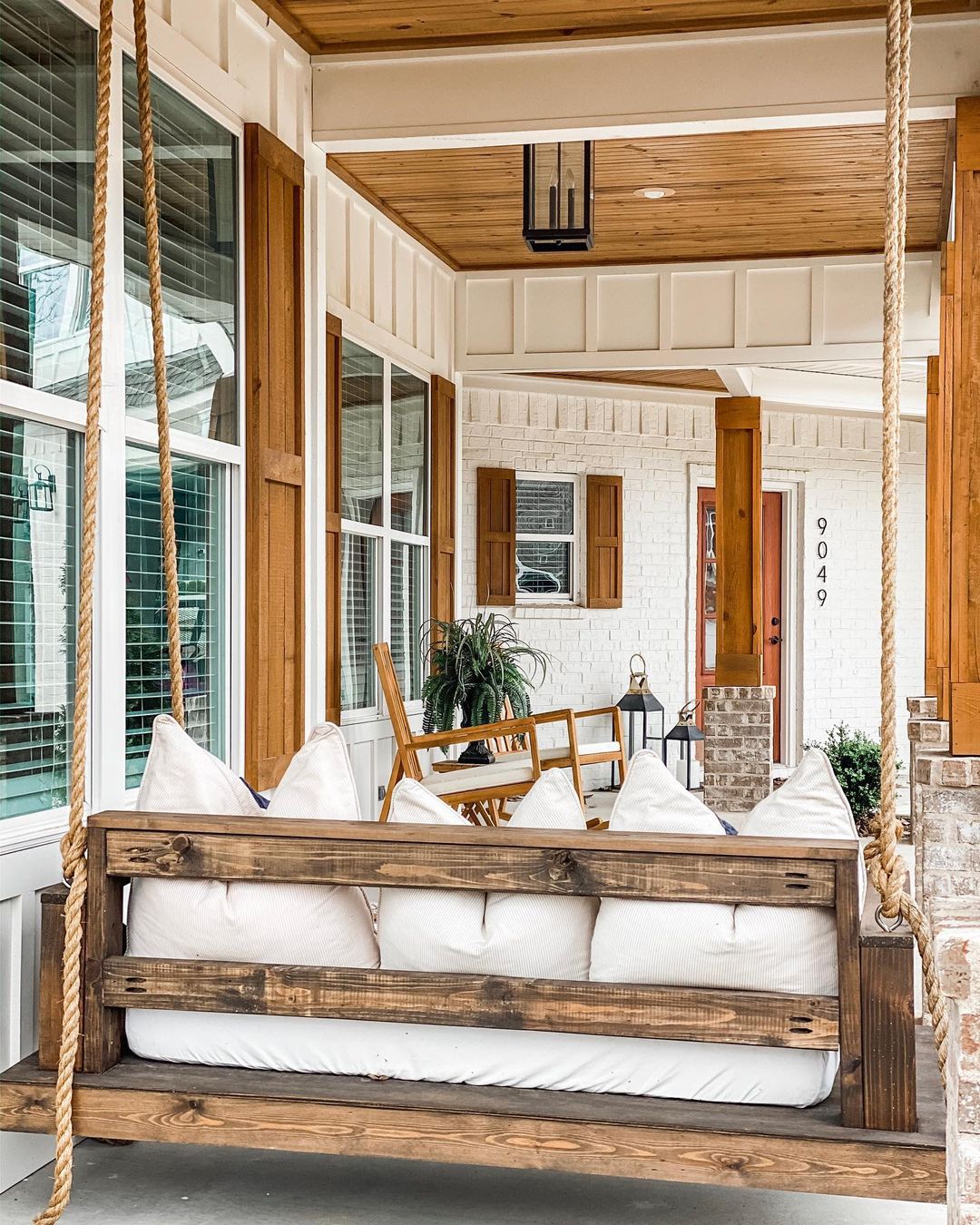 Farmhouse Style Home with Large Shutters and a Porch Swing. Photo by Instagram user @ourfergusonfarmhouse