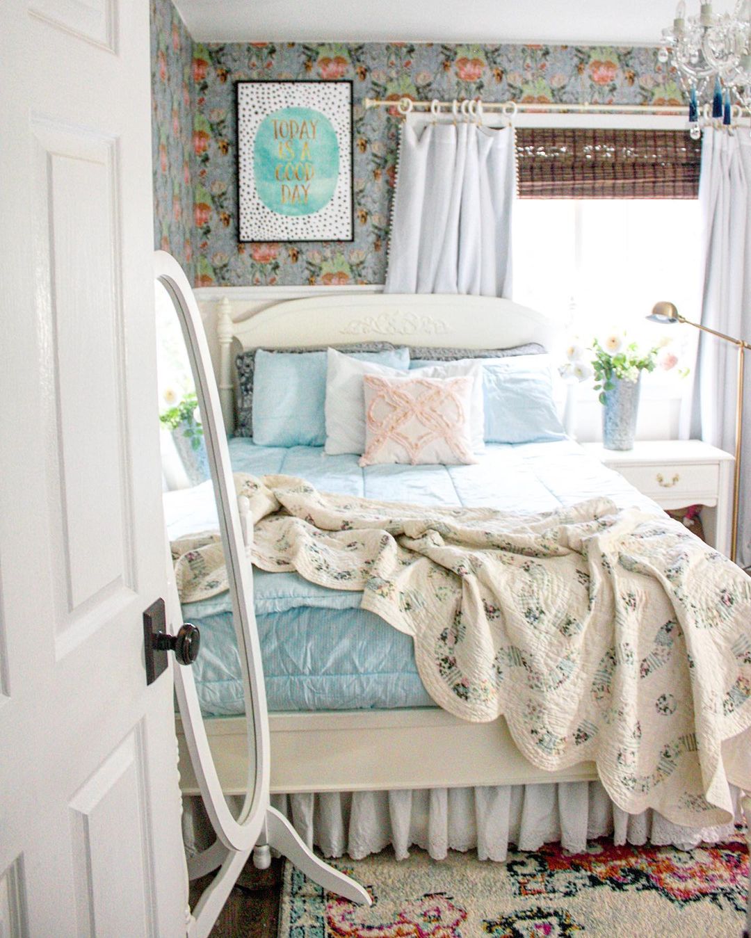 Farmhouse Bedroom with Blue Bedspread and Old Quilt on Top. Photo by Instagram user @brightyellowdoor