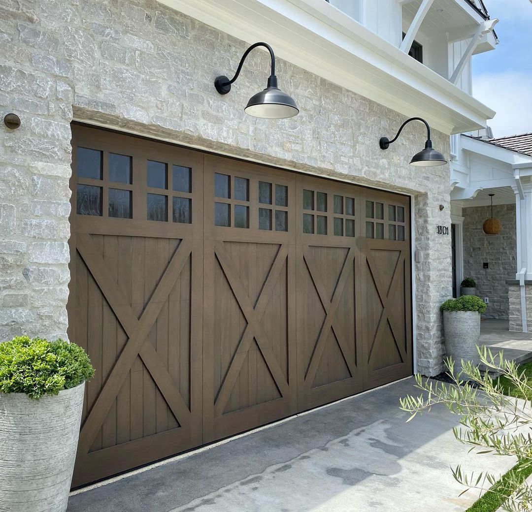 Farmhouse Style Home Utilizing Barn Style Garage Doors. Photo by Instagram user @ziegler_doors.inc