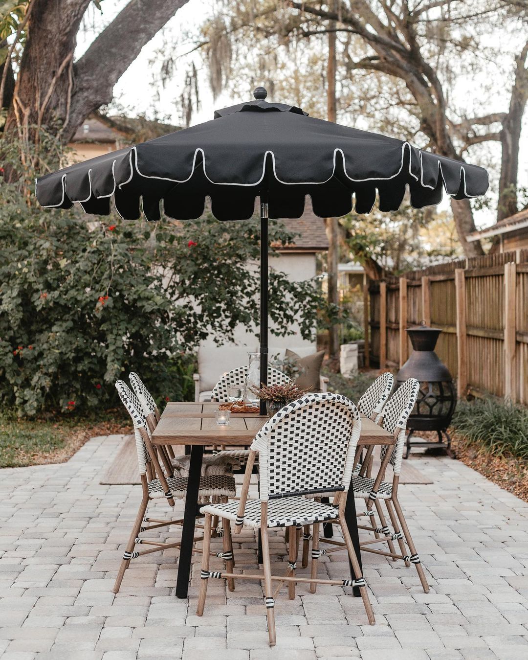 Backyard Patio with Table and Umbrella. Photo by Instagram user @jennasuedesign