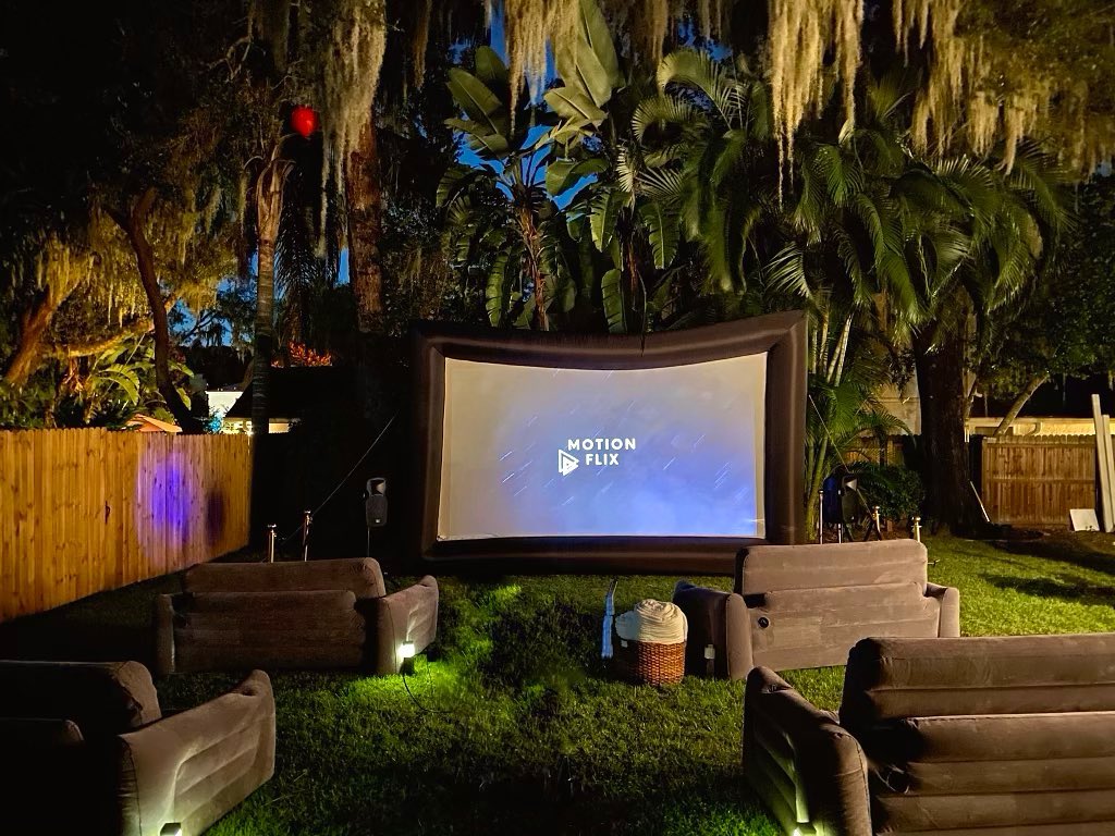 Backyard Movie Theater with Inflatable Chairs and Screen. Photo by Instagram user @motion.flix