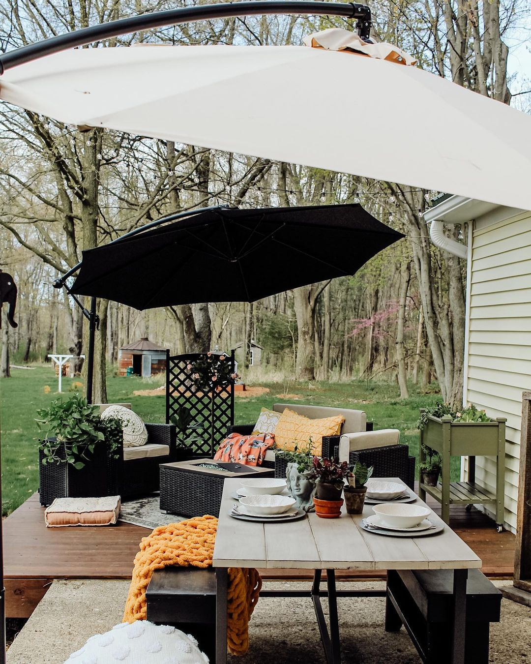 Backyard Patio with Large Umbrellas Hanging Overhead. Photo by Instagram user @twopawsfarmhouse