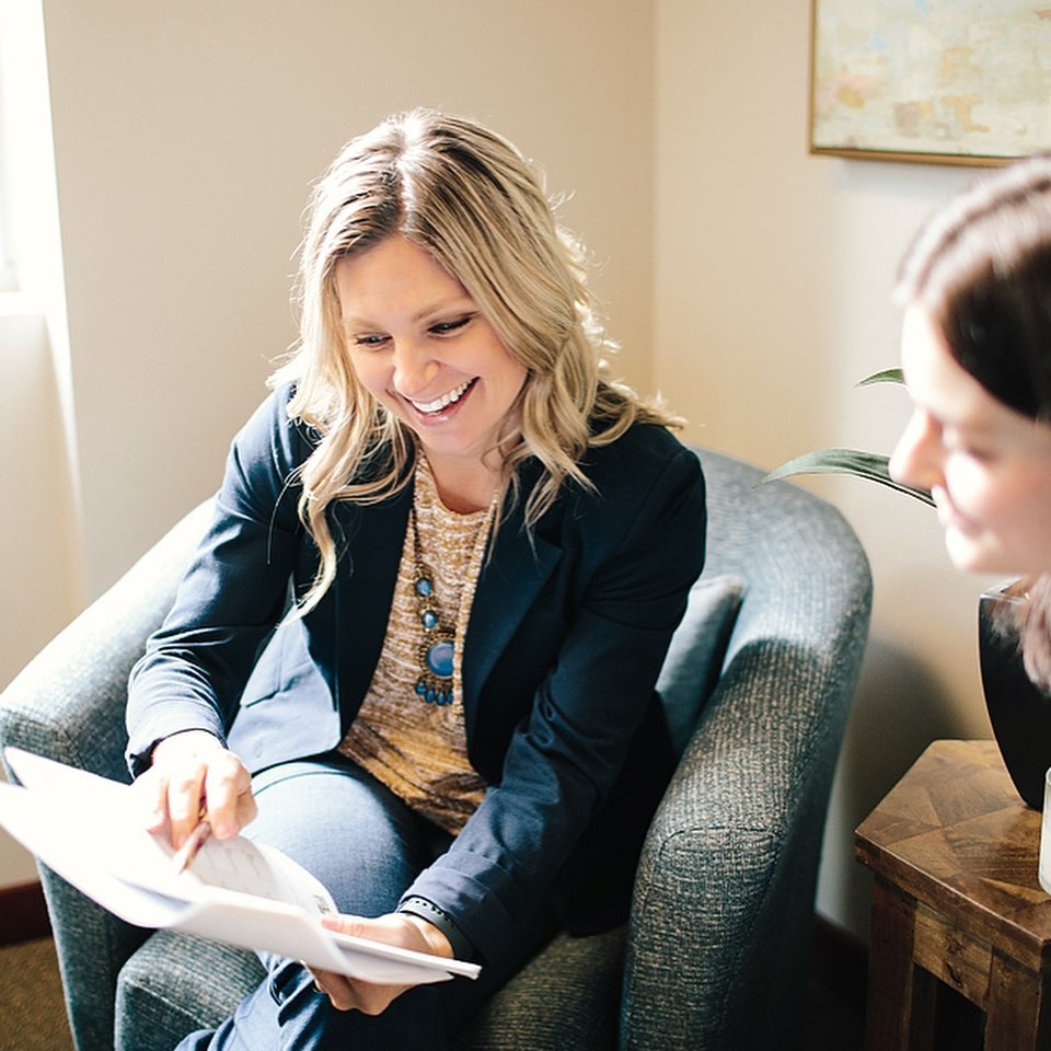 Women Sitting and Talking Through a Document with Another Woman. Photo by Instagram user @homewithhiggs