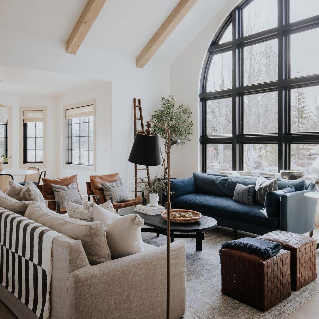 Gorgeous neutral-toned living room with large window. Photo by Instagram User @chrislovesjulia