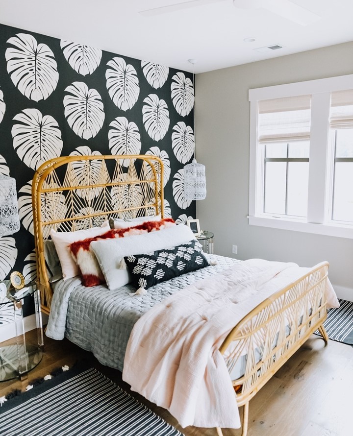 Tropical bedroom with large palm leaf wallpaper. Photo by Instagram User @shorelineconstructionsc