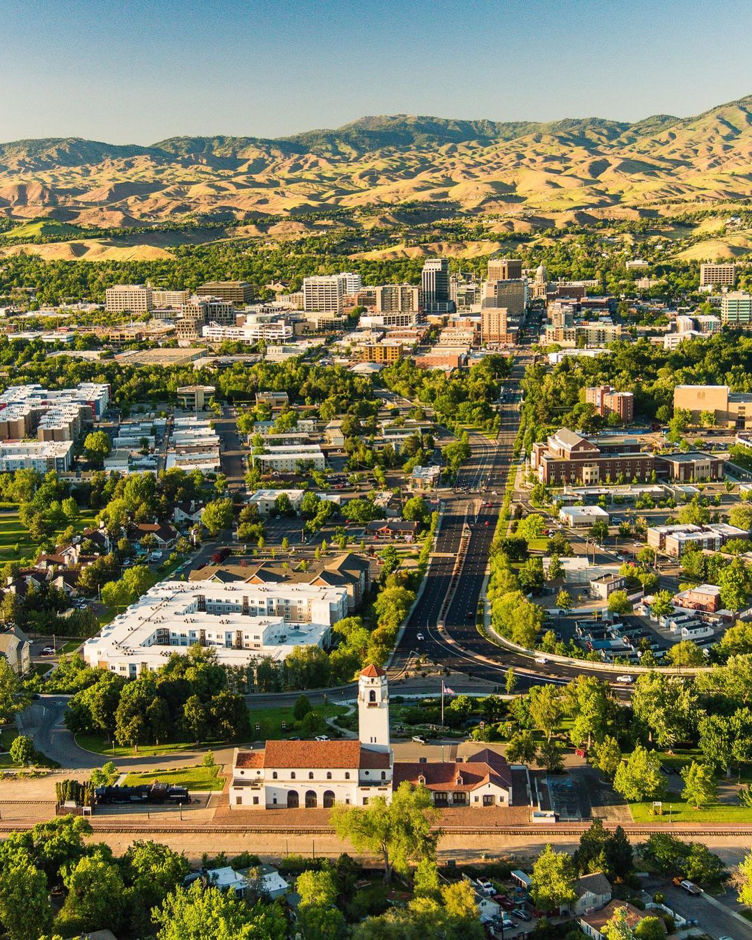 Drone Photo of Boise, ID at Golden Hour with the Mountains in the Background. Photo by Instagram user @chadcasephotovideo