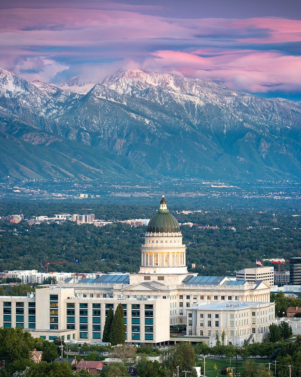 View of the Utah Capitol Building in Salt Lake City, UT with the Mountains in the Background. Photo by Instagram user @adambarkerphotography