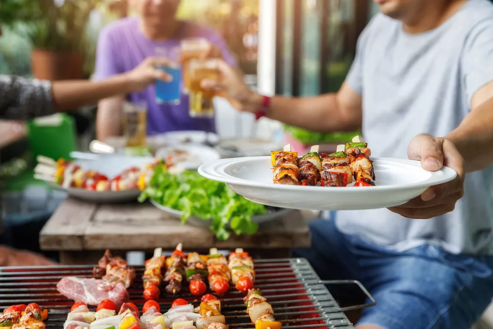 Person with Food on a Plate Handing It to Someone