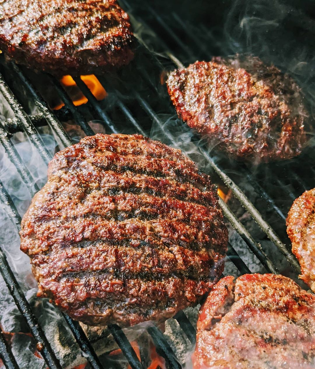 Burgers Cooking on a Grill. Photo by Instagram user @can2_bbq