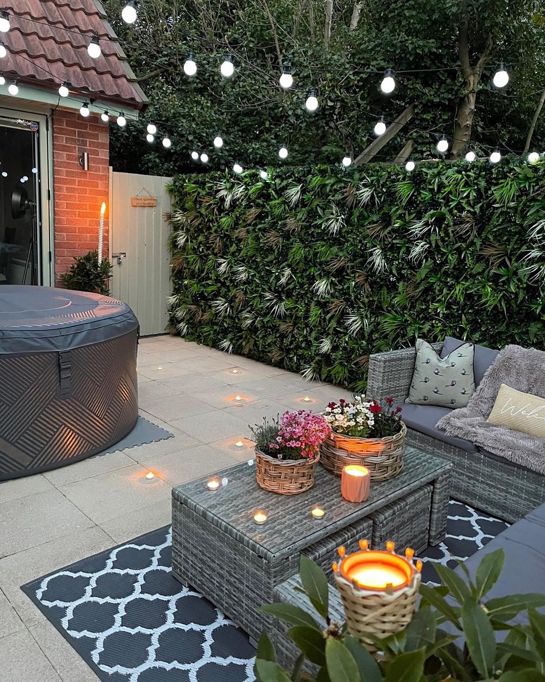 Backyard Sitting Area on a Patio with Lots of Lights Overhead. Photo by Instagram user @no1_home_decor