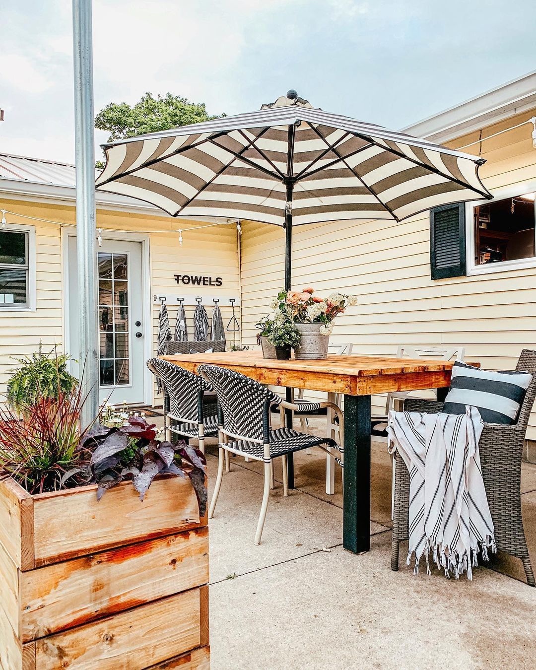 Backyard Patio Space with an Umbrella Table. Photo by Instagram user @our_forever_farmhouse