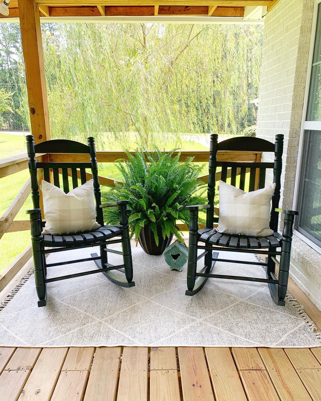 Updated Black Rocking Chairs with White Pillows. Photo by Instagram user @southern_styleandhome