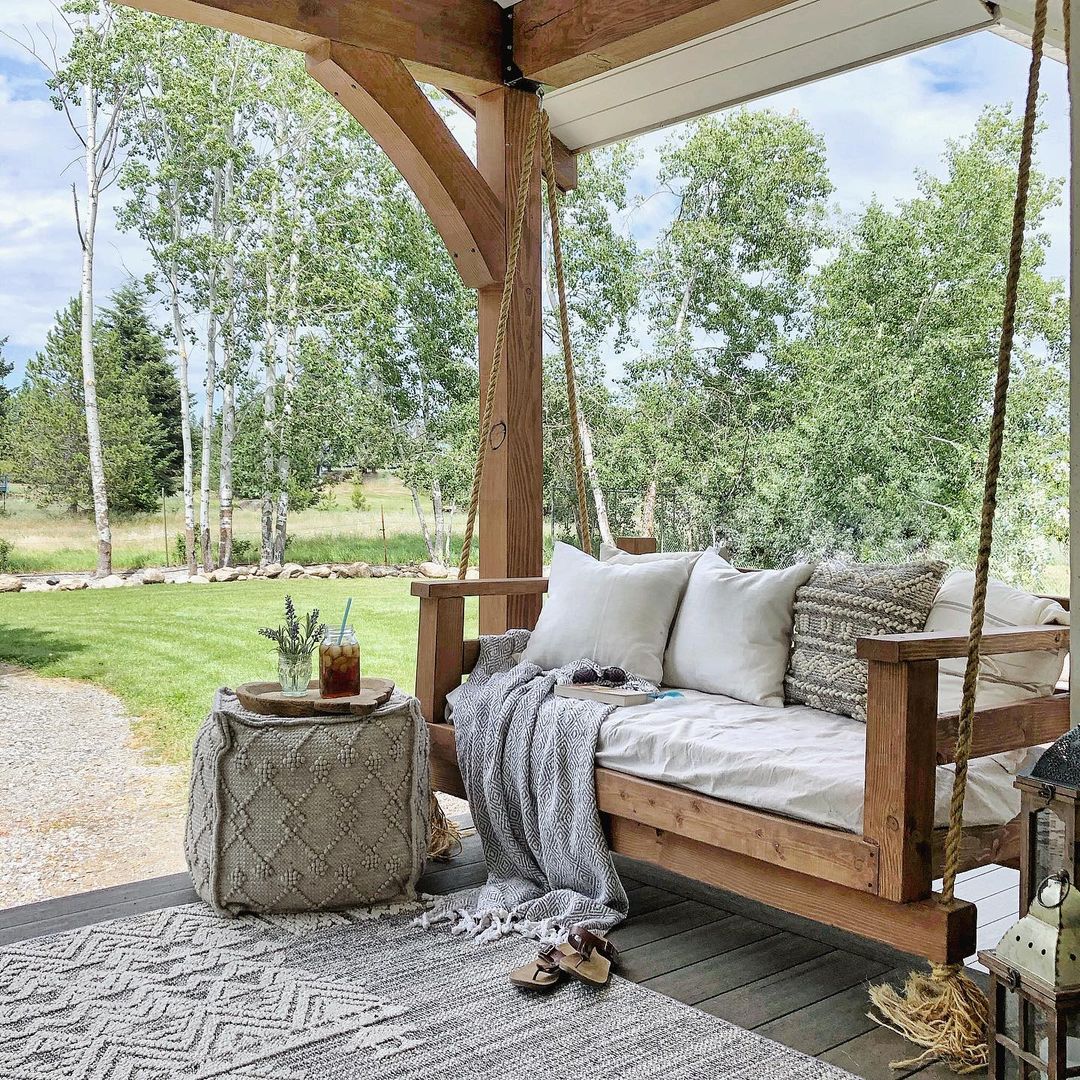 Large Hanging Porch Swing with Woven Ottoman Nearby. Photo by Instagram user @lavenderbrookfarm