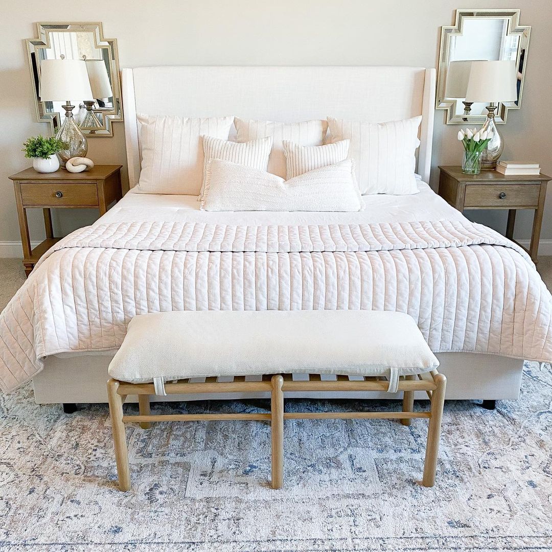 Bedroom with New Bedding and Foot Stool in Front. Photo by Instagram user @lovelywhitehome