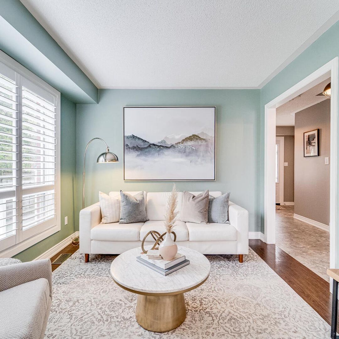 Living Room with Teal Walls and White Furniture. Photo by Instagram user @willowanddovestudios