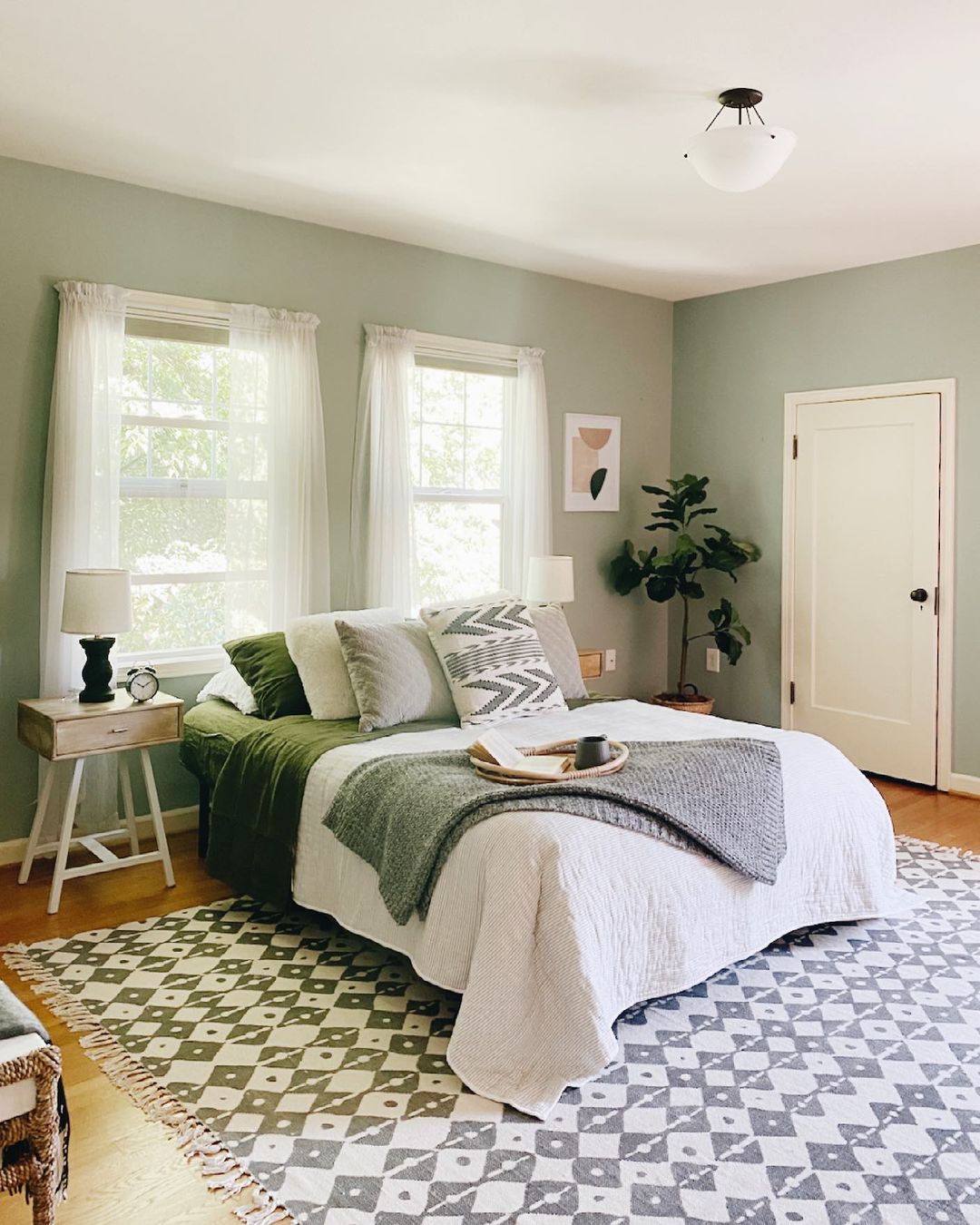 Simple Bedroom with Blanket Draped Over Bed. Photo by Instagram user @sarahshireed