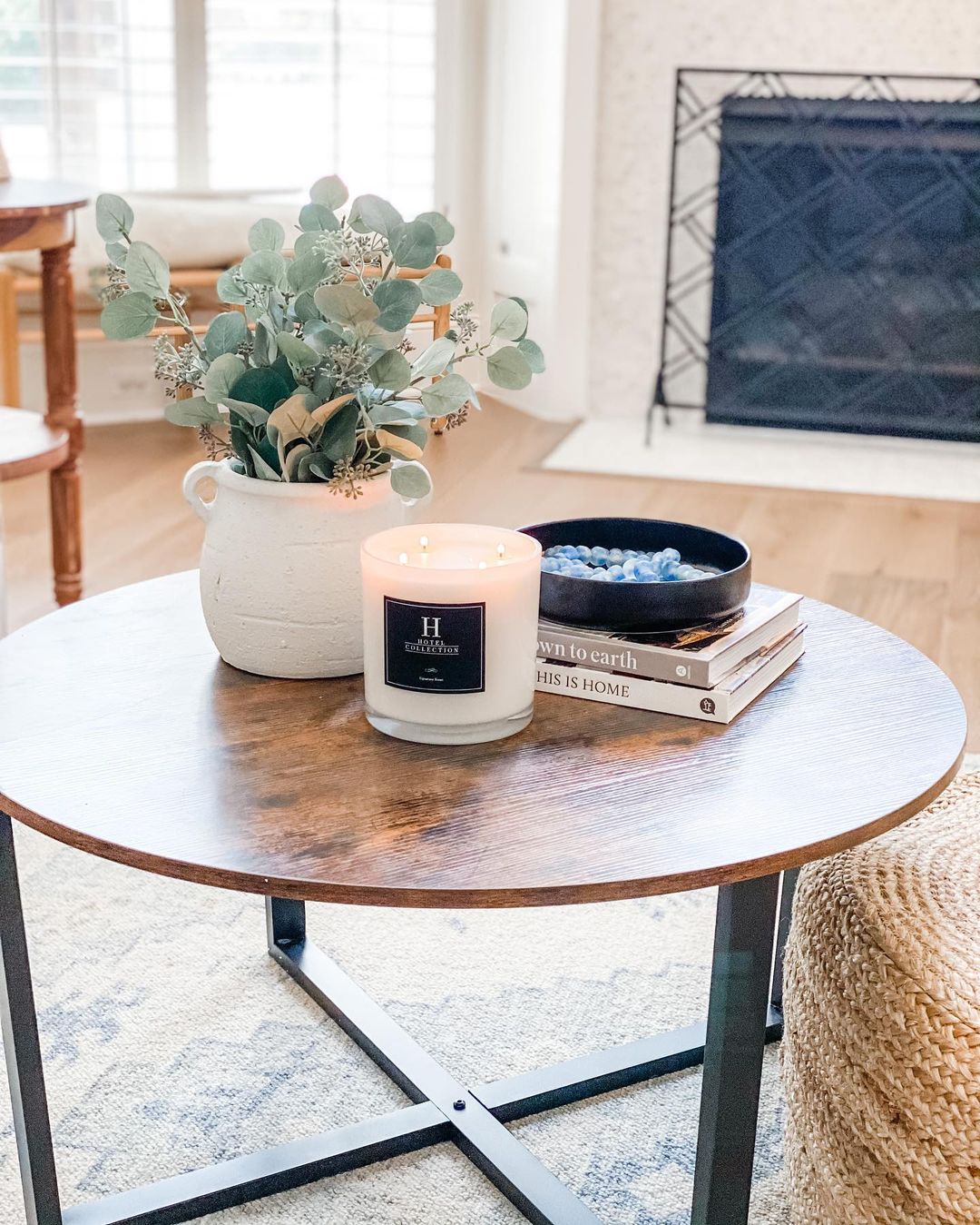 Coffee Table with Plant and Candle on Top. Photo by Instagram user @kayleymillerhome