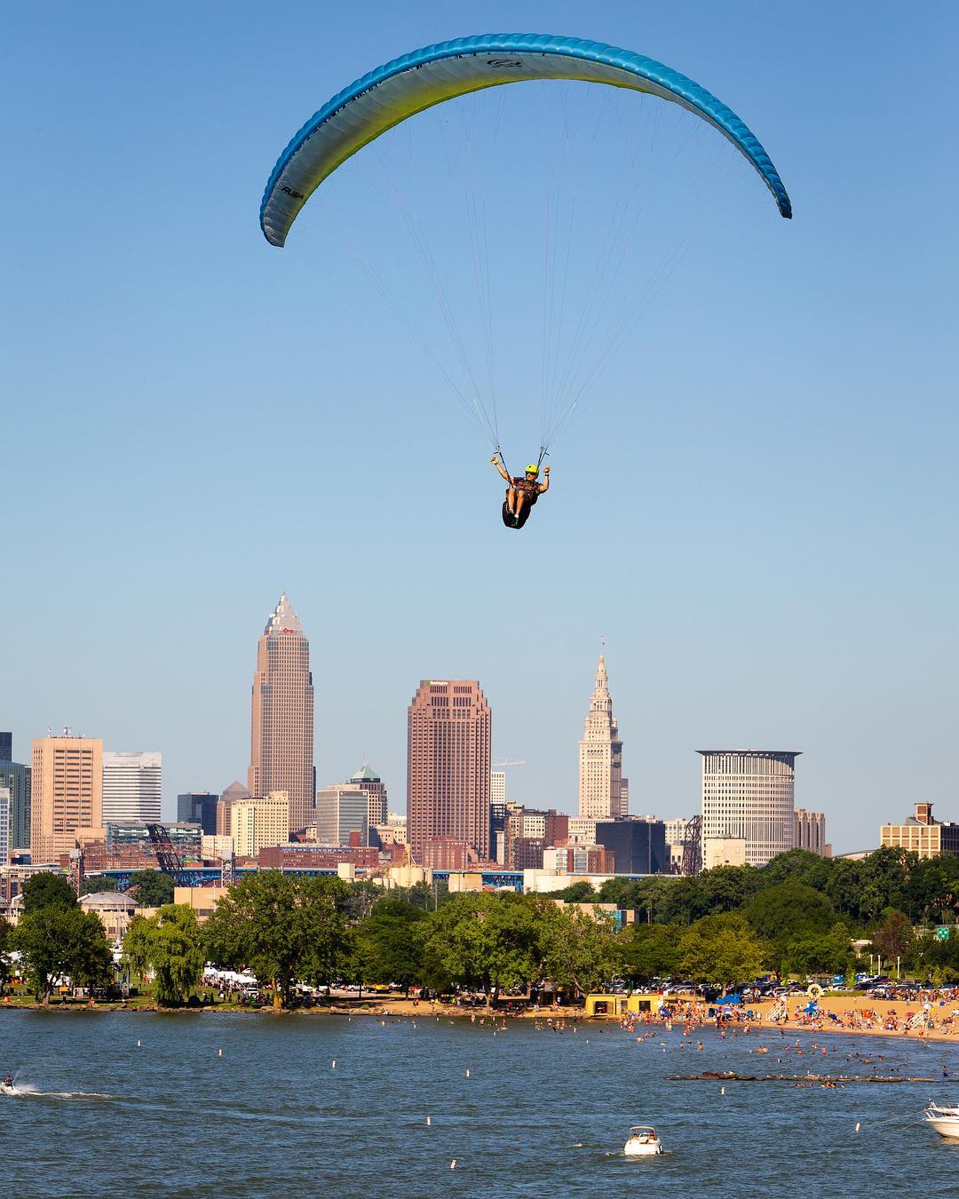 Person Paragliding Over the River at Edgewater State Park in Cleveland, OH. Photo by Instagram user @cyorkphoto