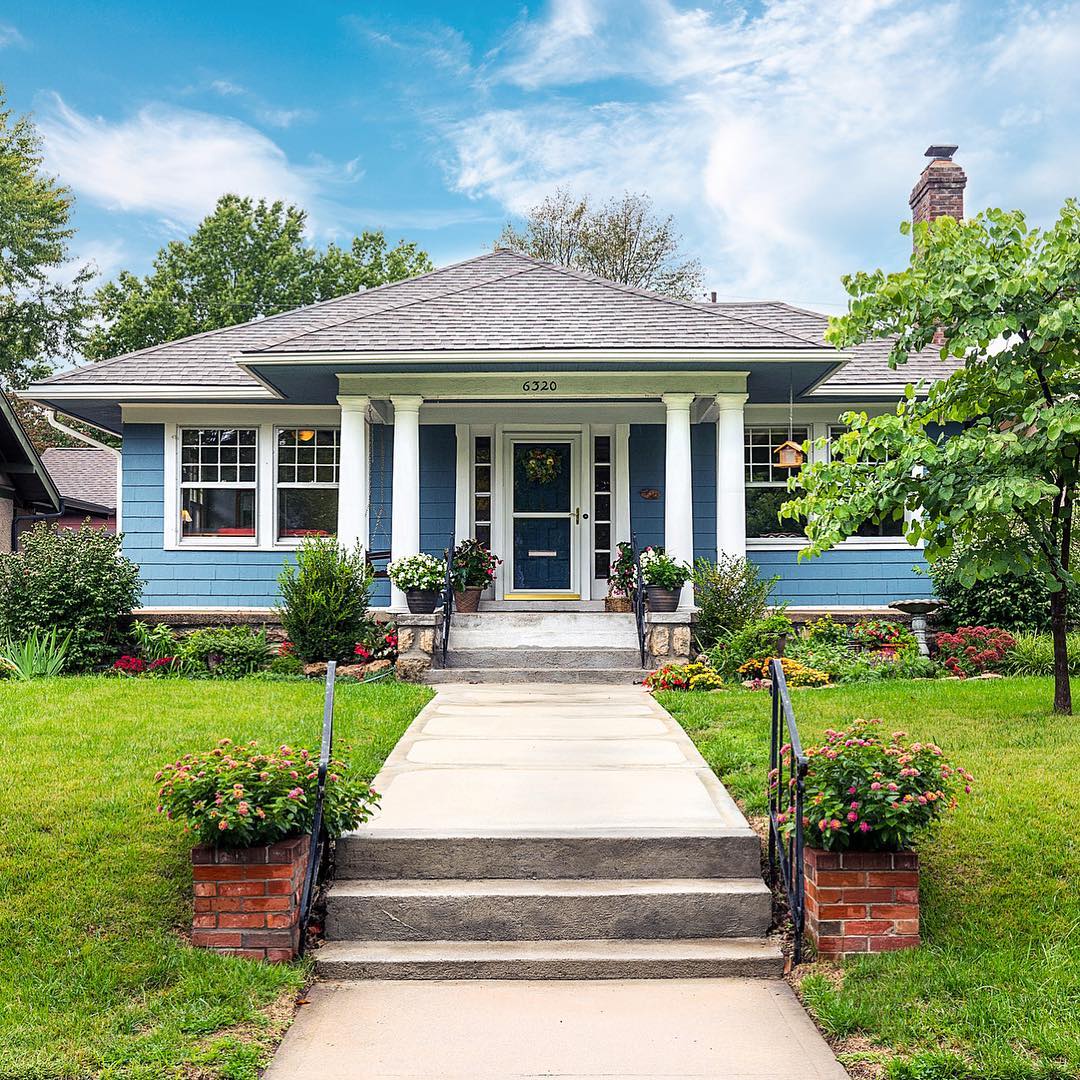 Blue four-square home with white columns located in Mission Lake neighborhood in Kansas City, MO. Photo by Instagram user @joesnappstudios