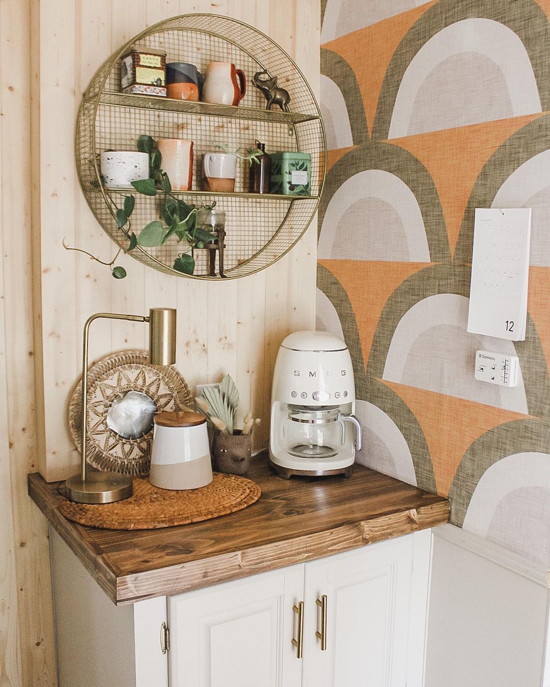 Corner coffee station in an RV with patterned wallpaper. Photo by Instagram user @the_ramblr_rv.