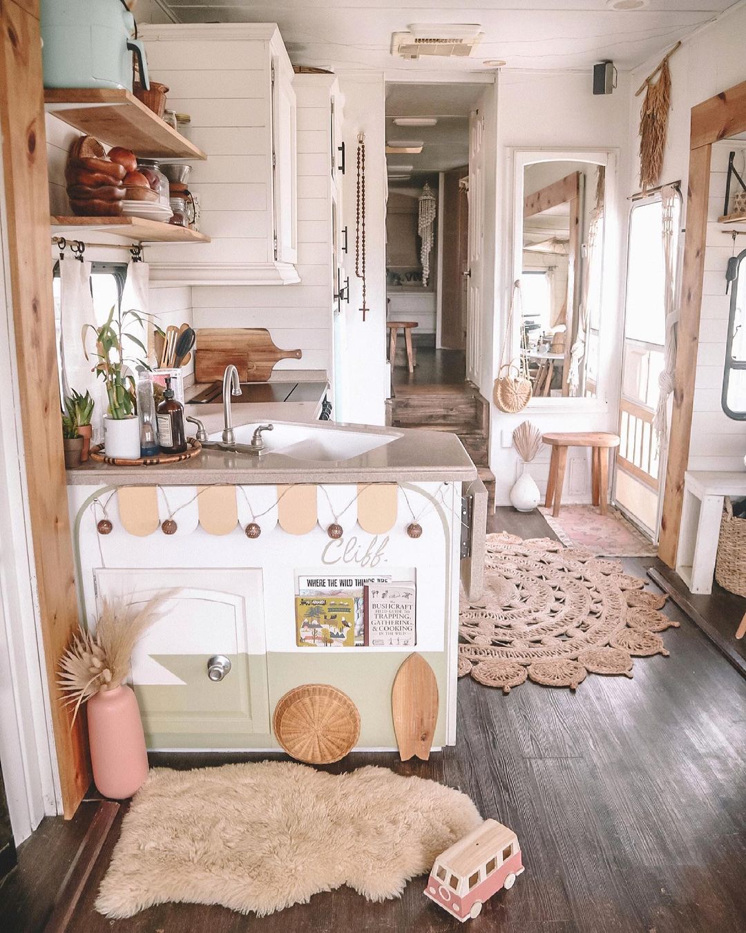 Kitchen area with kid play area in RV. Photo by Instagram user @shelbyadrift.