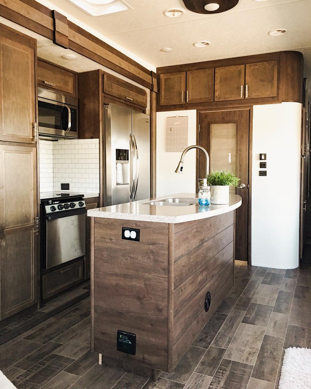 Kitchenette view in rustic RV. Photo by Instagram user @thetinywallsfamily.