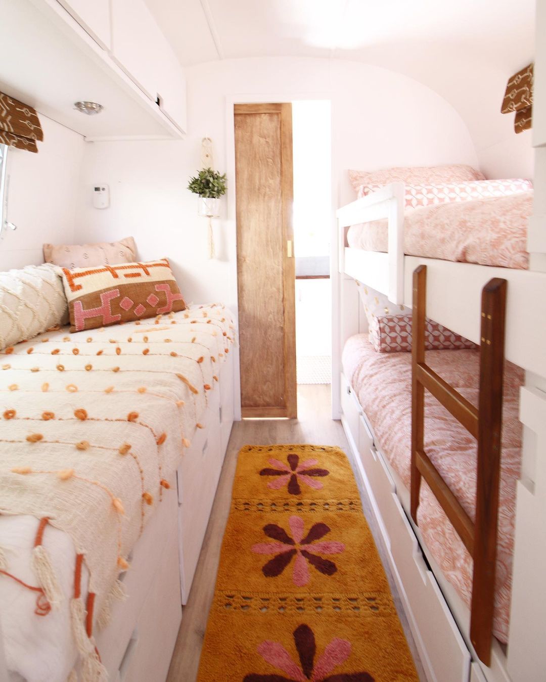 RV bedroom featuring a bunkbed and daybed with under-the-bed storage drawers. Photo by Instagram user @ourtinywander.