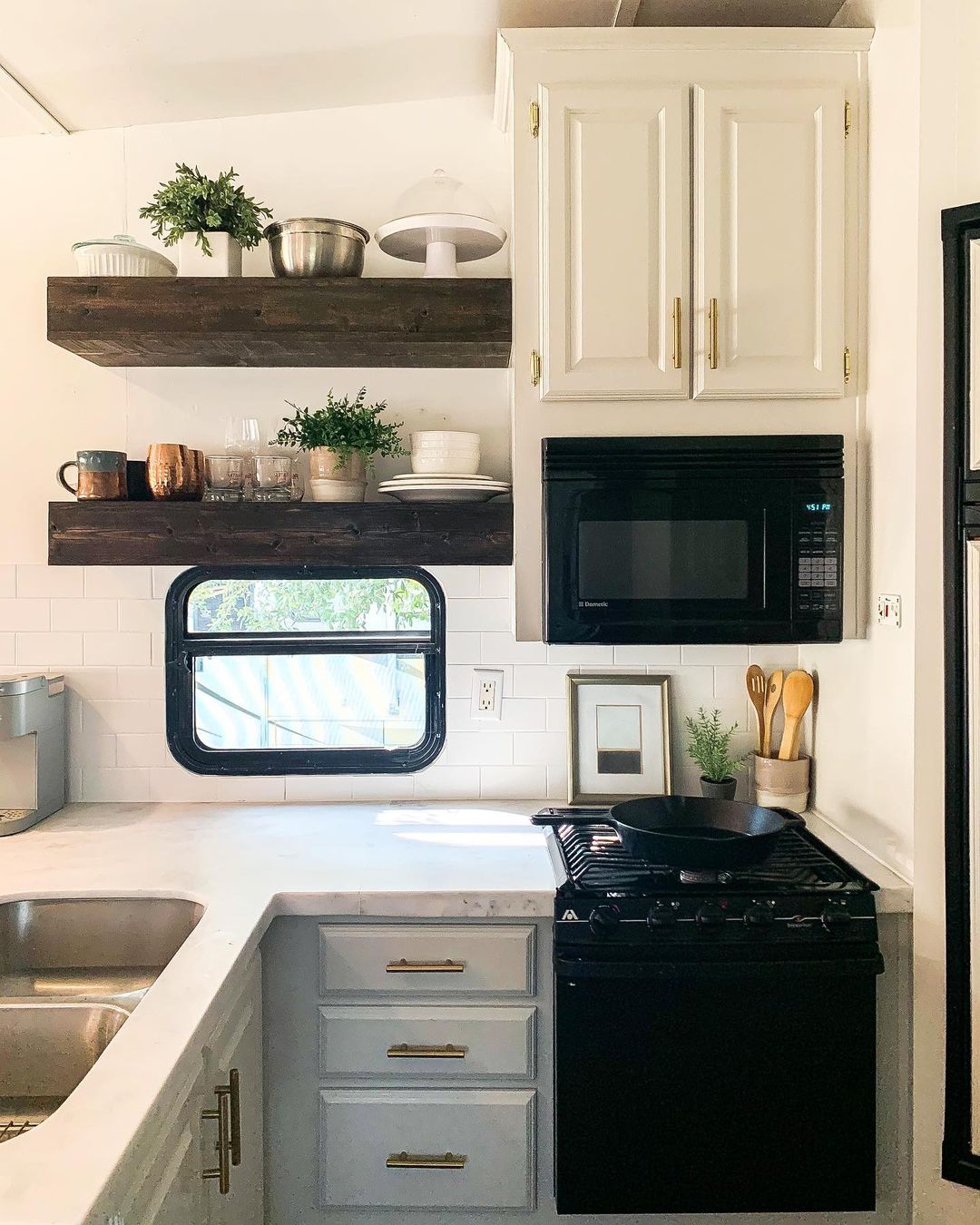 RV kitchen featuring floating shelves. Photo by Instagram user @jojothecamper.