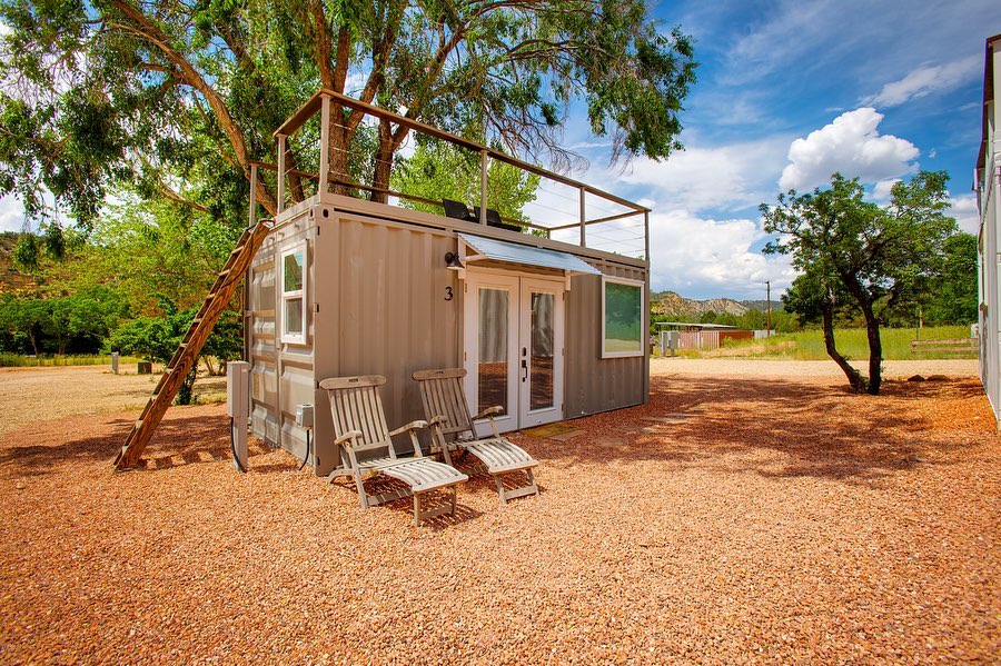 Single shipping container home with a rooftop lounge and double front doors. Photo by instagram user @ziontobryce