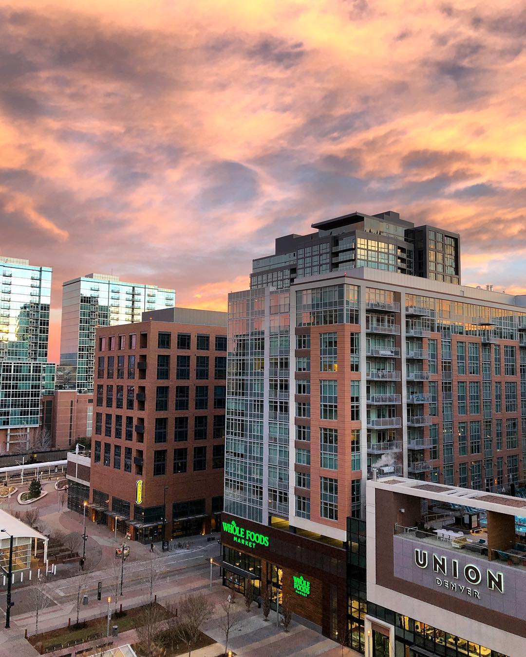 Nightime Photo of The Grand and Glass House Buildings in LoDo, Denver. Photo by Instagram user @randymajors