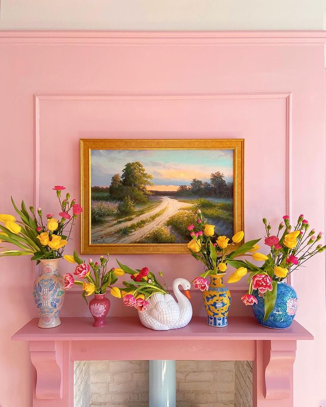 Fireplace Painted Pink with Bright Flowers to Accent. Photo by Instagram user @thehousethatcolourbuilt