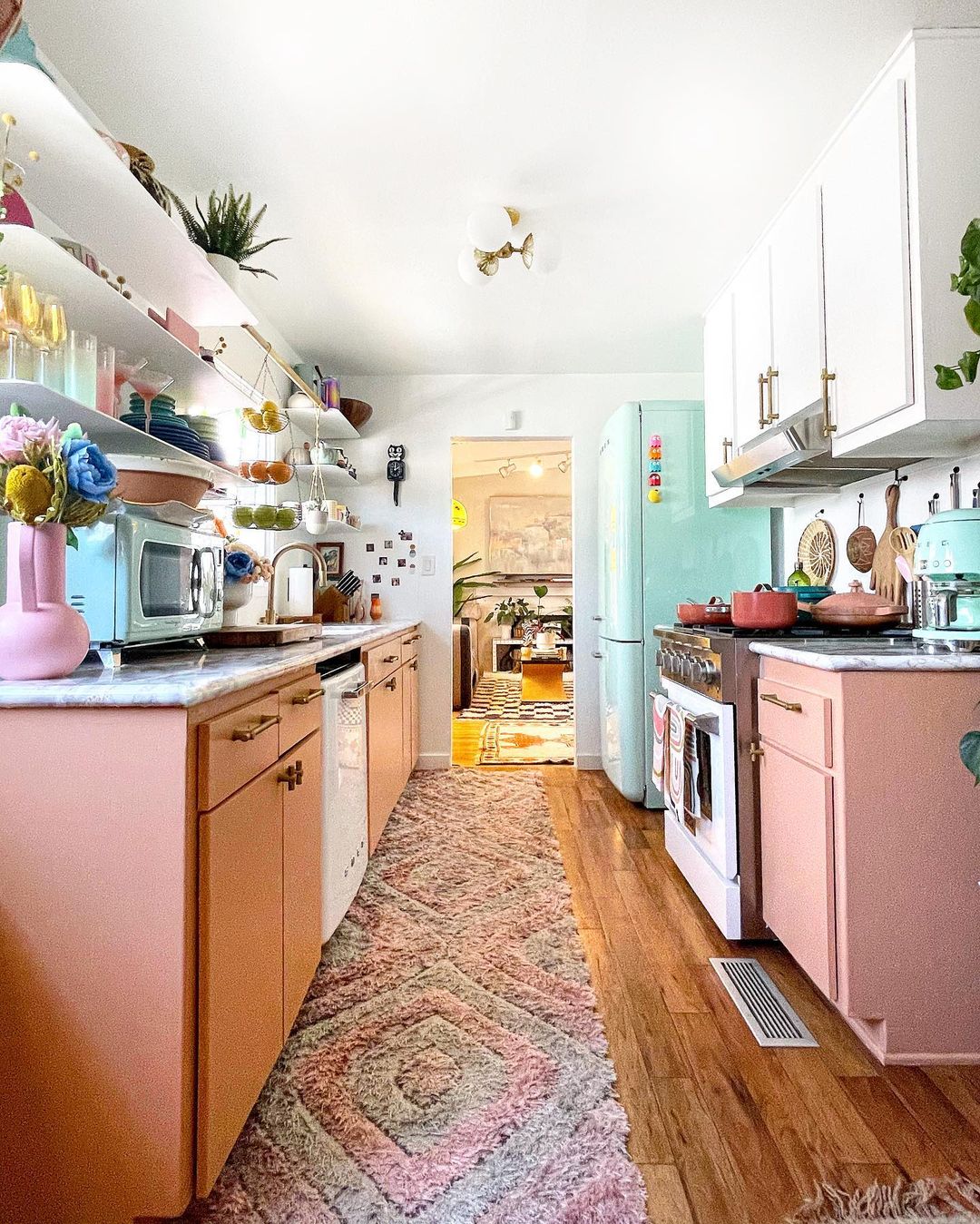 Older Kitchen Repainted with Pink Cabinets and White Oven. Photo by instagram user @candycoloredhome