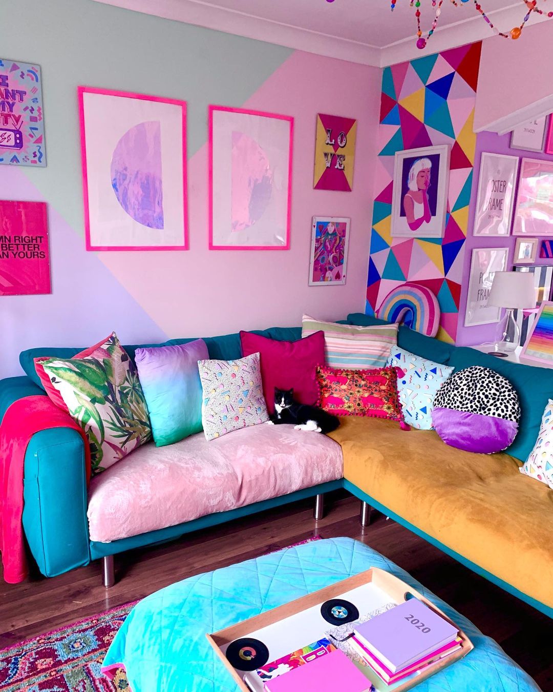 Living Area Painted Bright Pink with Vibrant Art Pieces. Photo by Instagram user @rachaelhavenhanddesign